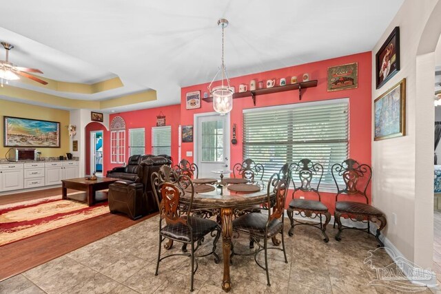 dining room with light hardwood / wood-style floors and ceiling fan