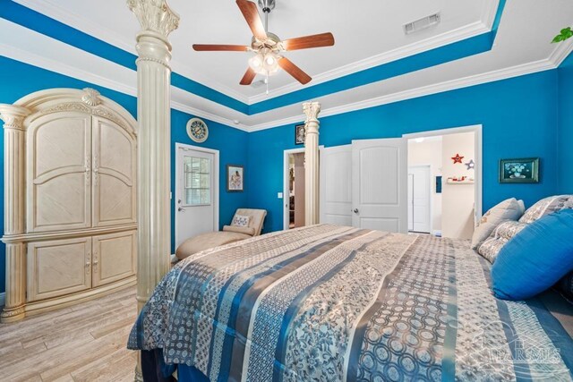 bedroom featuring ceiling fan, a raised ceiling, light hardwood / wood-style flooring, and crown molding