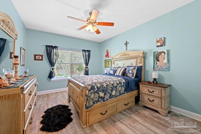 bedroom with light wood-type flooring and ceiling fan