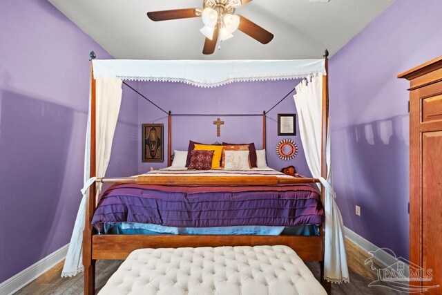 bedroom featuring hardwood / wood-style flooring, vaulted ceiling, and ceiling fan