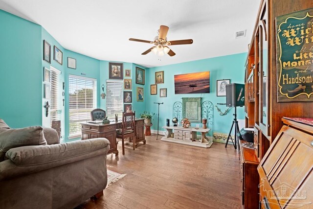 living area featuring ceiling fan and hardwood / wood-style floors