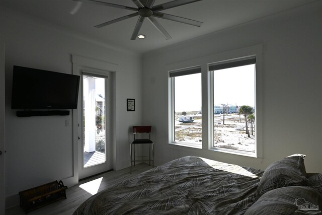 bedroom featuring hardwood / wood-style floors, ceiling fan, and access to outside