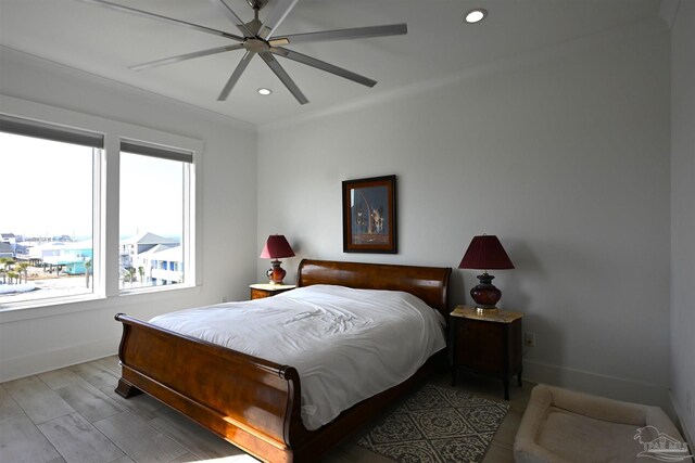 bedroom with ceiling fan and light hardwood / wood-style floors