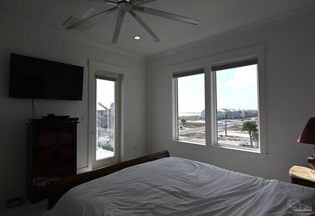 bedroom with multiple windows, ceiling fan, and crown molding