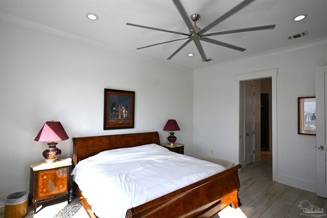 bedroom featuring ceiling fan, crown molding, and light wood-type flooring