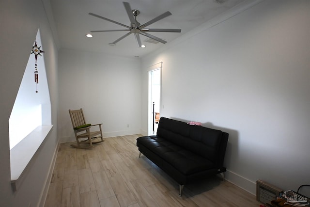 sitting room with light hardwood / wood-style flooring, ceiling fan, and ornamental molding