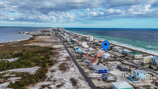 drone / aerial view featuring a water view and a view of the beach