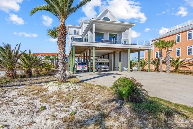 view of front of home with a balcony and a carport