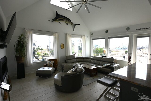 living room with hardwood / wood-style flooring, high vaulted ceiling, and a wealth of natural light