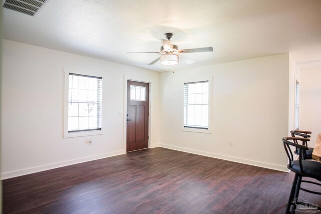 entryway with dark wood-type flooring and ceiling fan