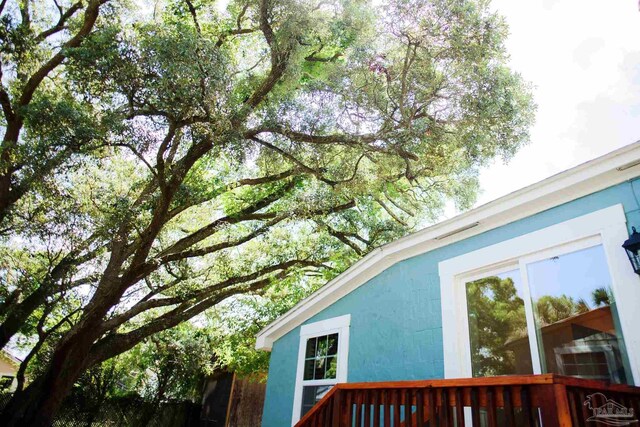 view of side of property featuring a wooden deck