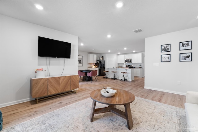 living room with light hardwood / wood-style floors