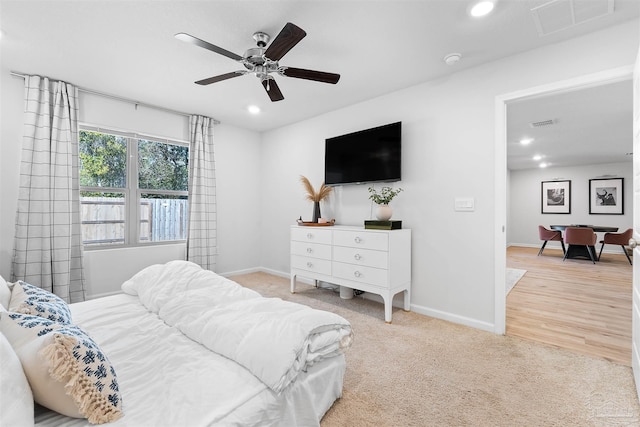 bedroom featuring ceiling fan and light carpet