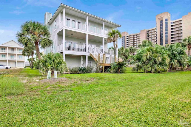 rear view of house featuring a yard