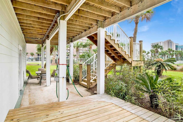 wooden terrace with a patio