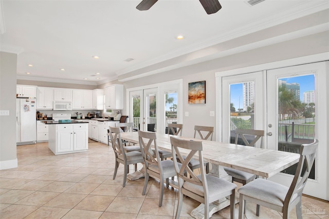 tiled dining area featuring crown molding, french doors, and plenty of natural light