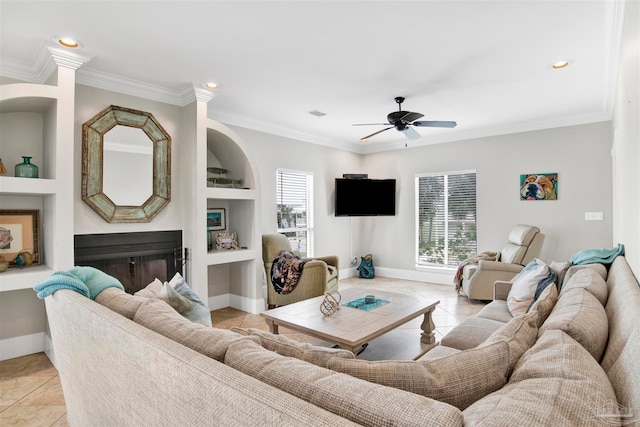 living room with built in shelves, light tile patterned floors, and a wealth of natural light