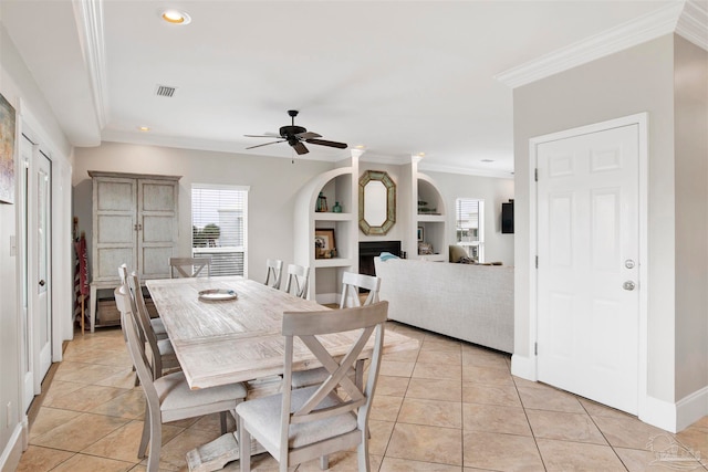 dining space with ceiling fan, ornamental molding, and light tile patterned floors