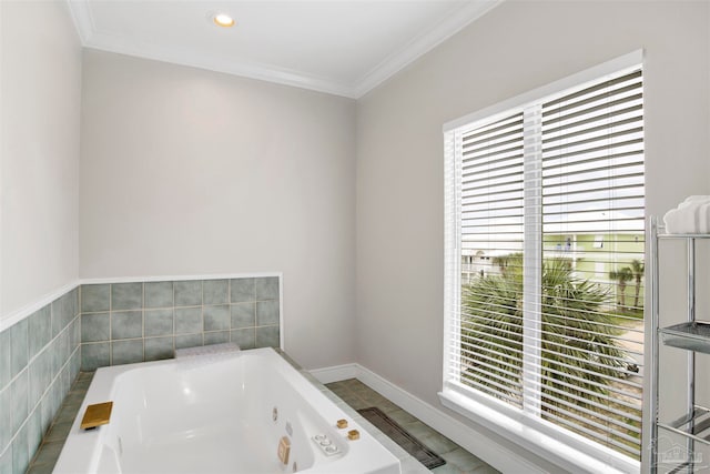 bathroom with a bathtub, a wealth of natural light, and ornamental molding