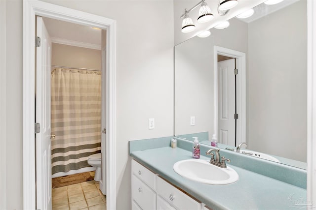 bathroom with tile patterned floors, vanity, toilet, and ornamental molding