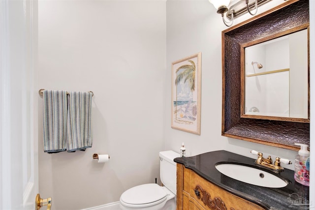 bathroom featuring vanity, toilet, and walk in shower