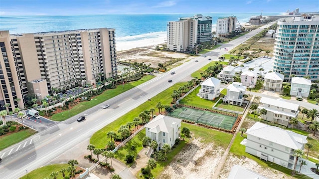 birds eye view of property featuring a water view and a beach view