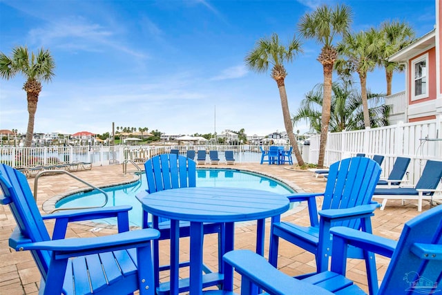 view of patio featuring a water view and a community pool