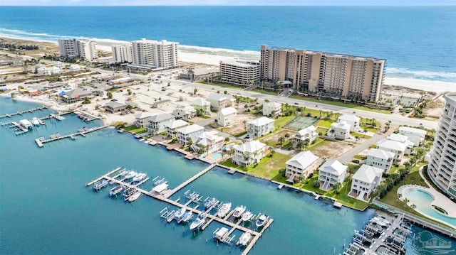 birds eye view of property featuring a water view and a beach view