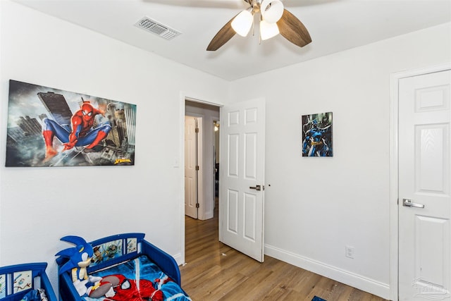 bedroom with hardwood / wood-style floors and ceiling fan