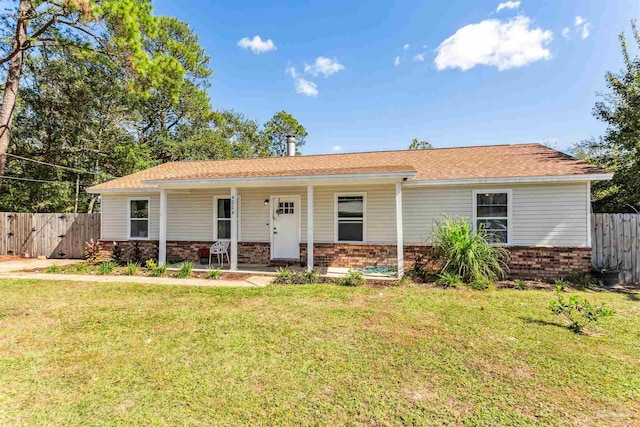 ranch-style house with covered porch and a front lawn