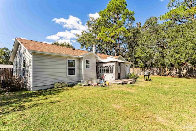 back of house with a yard