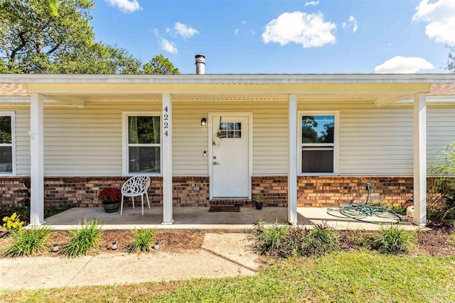 doorway to property featuring a porch