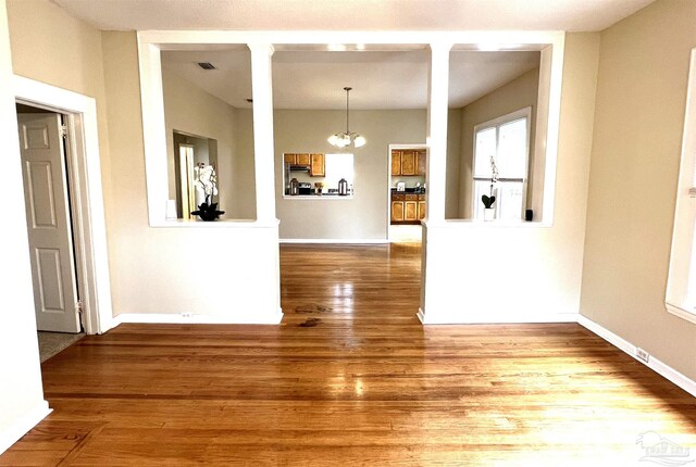 interior space with hardwood / wood-style flooring and an inviting chandelier