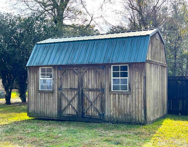 view of outbuilding featuring a lawn