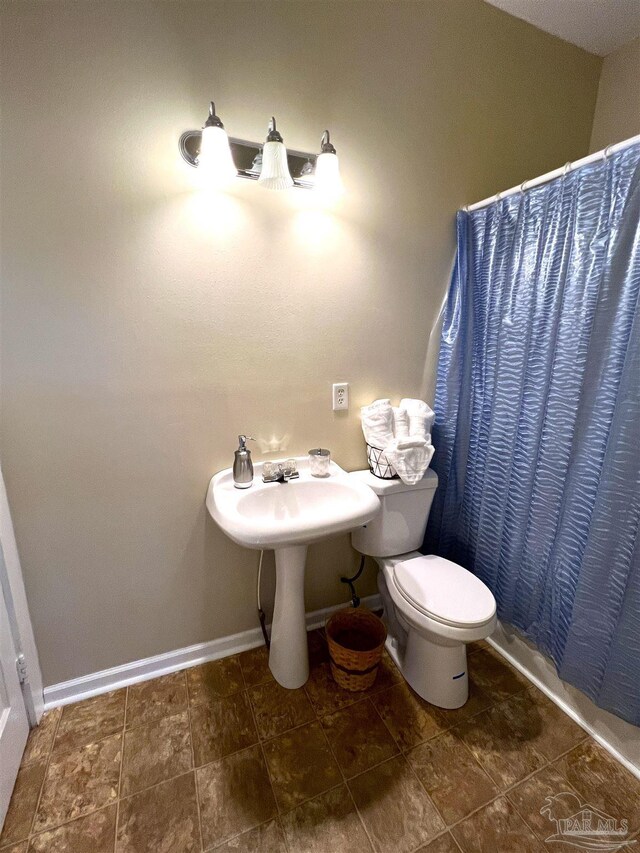 bathroom with toilet and walk in shower