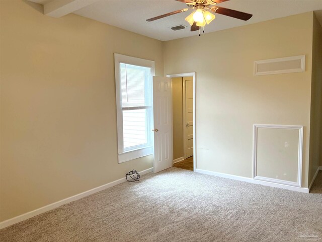 spare room featuring light colored carpet and ceiling fan