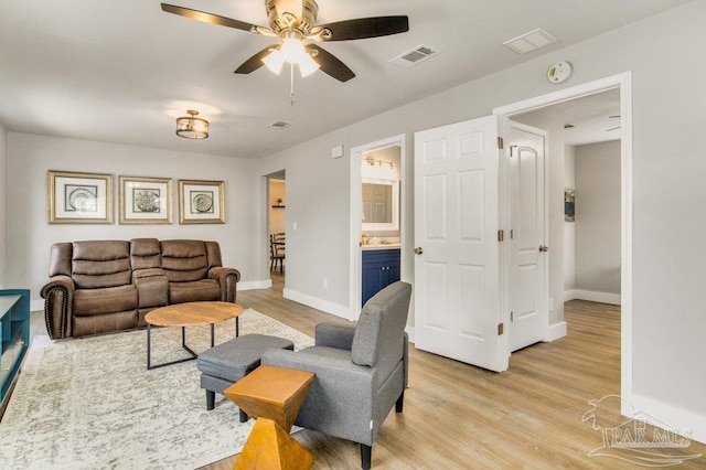 206 N G St, Pensacola, FL 32502 - living area with light wood-style floors, baseboards, and ceiling fan