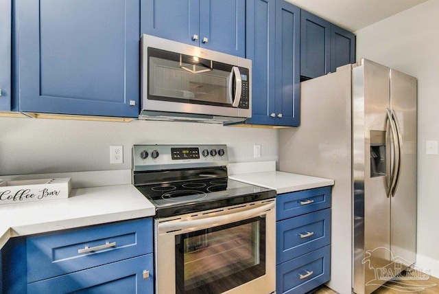 206 N G St, Pensacola, FL 32502 - kitchen featuring blue cabinets, stainless steel appliances, and light countertops