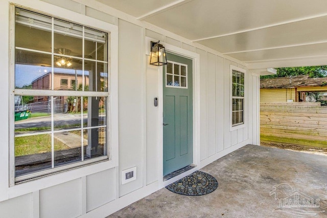 206 N G St, Pensacola, FL 32502 - entrance to property featuring fence, board and batten siding, and covered porch
