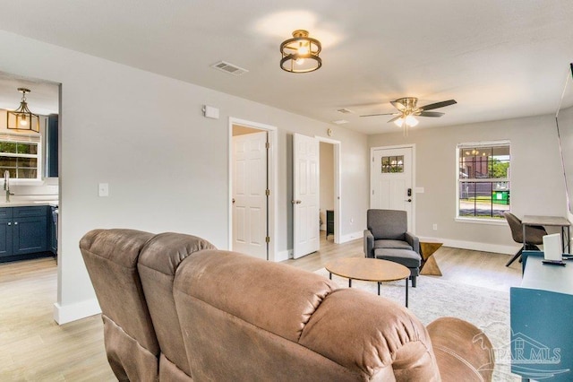 206 N G St, Pensacola, FL 32502 - living room featuring light wood finished floors, baseboards, and ceiling fan