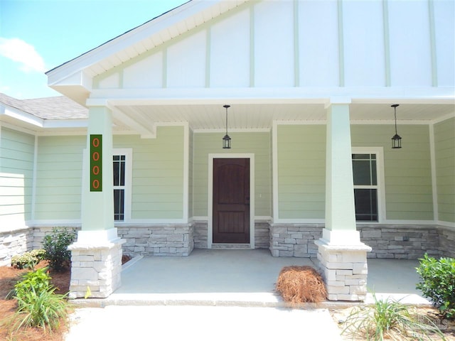 view of exterior entry with covered porch