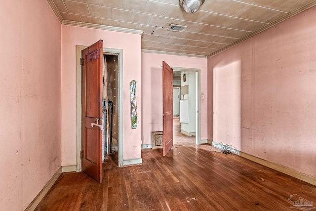 unfurnished room with crown molding and hardwood / wood-style floors