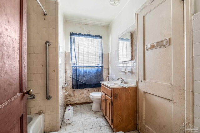 full bathroom featuring tiled shower / bath, tile walls, vanity, toilet, and tile patterned floors