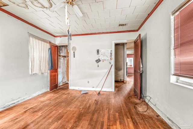 interior space featuring crown molding and hardwood / wood-style floors