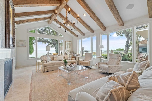 sunroom / solarium with plenty of natural light, a notable chandelier, lofted ceiling with beams, and a tiled fireplace