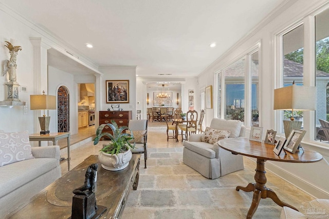 living area with a chandelier, ornamental molding, baseboards, and recessed lighting