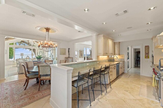 kitchen featuring light brown cabinetry, decorative backsplash, sink, custom range hood, and appliances with stainless steel finishes