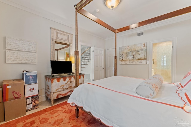 bedroom featuring visible vents, connected bathroom, ornamental molding, and carpet flooring