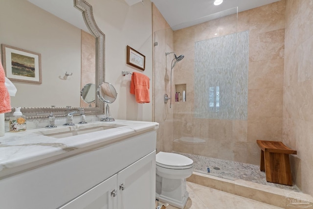 full bathroom featuring tile patterned flooring, vanity, toilet, and a walk in shower