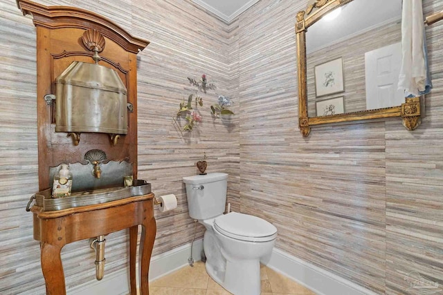 bathroom featuring tile patterned flooring, toilet, and baseboards